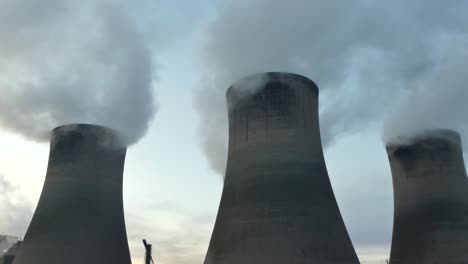 Power-plant-cooling-towers-fossil-fuel-smoke-air-pollution-from-under-chimney-stacks