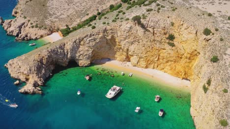 Secluded-sandy-beach,-Golden-Bay,-surrounded-by-the-sheer-cliffs-on-Croatian-island-Krk