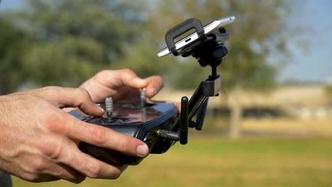 Close-Up-View-drone-pilot-operating-professional-quadcopter