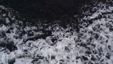 Waves-created-by-a-moving-ship-with-white-foam-rising-up-in-a-dark-deep-sea