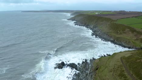 Aerial-drone-shot-of-on-Ireland’s-beautiful-green-south-coast-on-a-cloudy-day