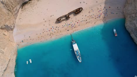 Aerial-Top-Down-Footage-Of-Tourists-Visiting-Shipwreck-Bay,-Navagio-Beach,-Zakynthos,-Greece