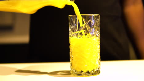 Pouring-Orange-Juice-In-A-Glass-With-Beautiful-Design---Closeup-Shot