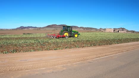 Tractor-pulling-plow-through-a-harvested-field-–-Yuma-Arizona