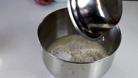 Adding-Yeast-To-Flour-In-a-Mixing-Bowl