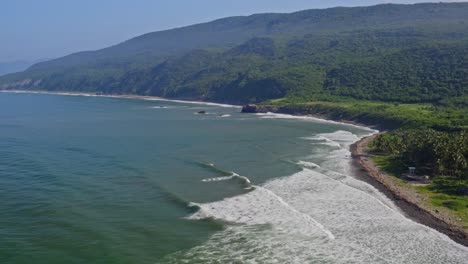 Aerial:-Beautiful-Mexican-Pacific-coast-on-tropical-day,-ocean-waves-crashing-on-beach-paradise