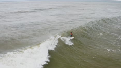 Surfista-Experimentado-Cabalgando-Y-Chocando-Contra-Una-Gran-Ola-De-Barril,-Vista-Aérea-De-México
