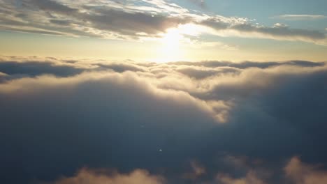 Aerial-shot-above-the-clouds-in-4k-while-sunset