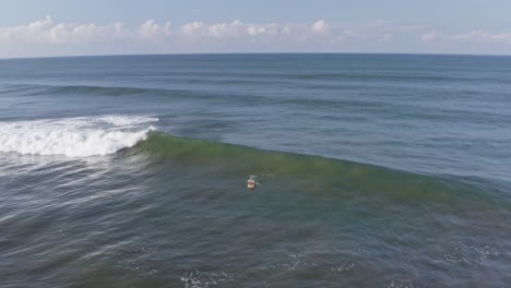 Aerial:-surfer-attempting-to-catch-a-big-wave,-then-pulling-out