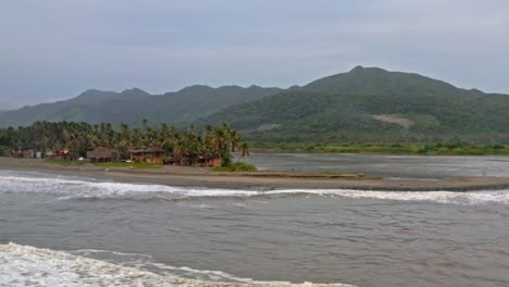 Remote-Mexican-Pacific-coast,-waves-crashing-against-tropical-beach,-aerial-view