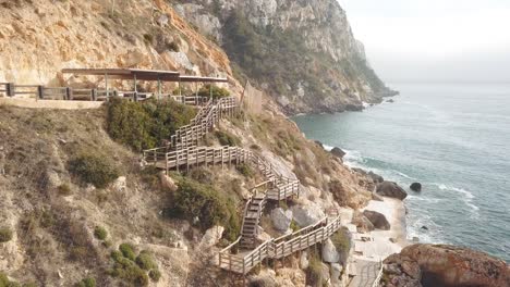 Aerial-shot-in-4k-of-wooden-stairs-to-a-rocky-swimming-spot-in-Mallorca