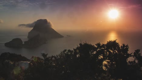Stunning-4k-Time-Lapse-of-Sunset-at-Es-Vedra-Ibiza-in-Spain-with-moving-clouds-in-the-mountains