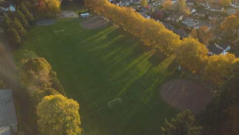Aerial-footage-of-a-beautiful-soccer-field-in-a-friendly-neighborhood-in-Portland,-Oregon---City-park-for-sport-and-fitness-while-sunset