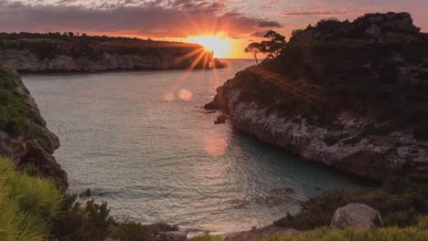 Sunrise-Time-Lapse-in-4K-in-paradise-at-the-beautiful-tropical-bay-Calo-des-Moro-with-clear-turquoise-water-in-Mallorca,-Spain
