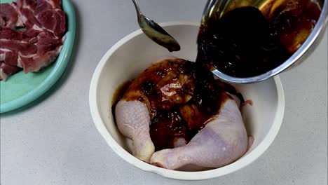 Pouring-Marinade-Over-Chicken-Legs