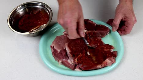 Rubbing-Spice-Paste-Into-Pork-Meat-Slices