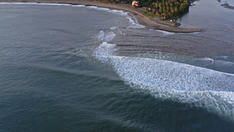 Beautiful-waves-rolling-in-and-crashing-on-beach,-aerial-top-down-reveal