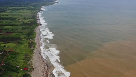 Aerial:-muddy-freshwater-mixing-with-seawater-at-river-mouth-estuary