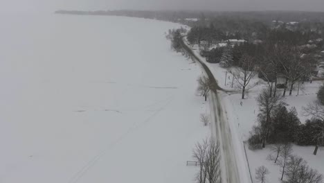 Drone-Flying-Over-Snowy-Frozen-Lakeshore-in-Southern-Ontario
