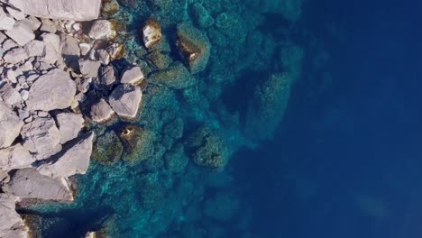 4k-top-down-shot-of-rocks-in-clear-turquoise-water---Mediterranean-Sea-West-coast---Cristal-clear-ocean---Clean-water