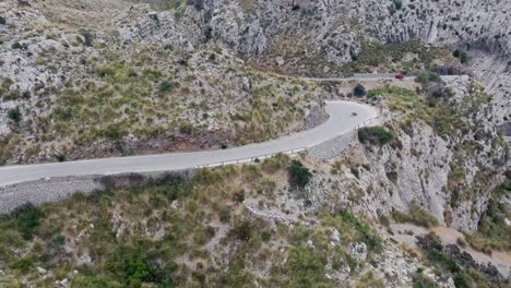 Stunning-4k-aerial-footage-of-two-people-downhill-skating-in-epic-landscape-in-Mallorca---Skating-through-serpentines---Crazy-outdoor-hobby-adrenaline-junkies---Sa-Calobra-in-Serra-de-Tramuntana