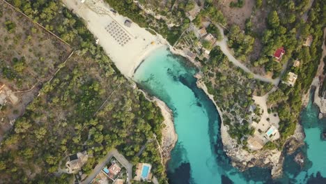 4k-top-down-shot-if-a-bay-in-Mallorca-with-blue-clear-turquoise-water---east-coast---Spain---Espana