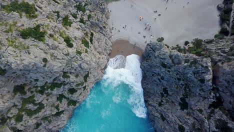 Top-down-view-of-Sa-Calobra,-Majorca---Mediterranean-Sea-holiday---Beach-with-tourists