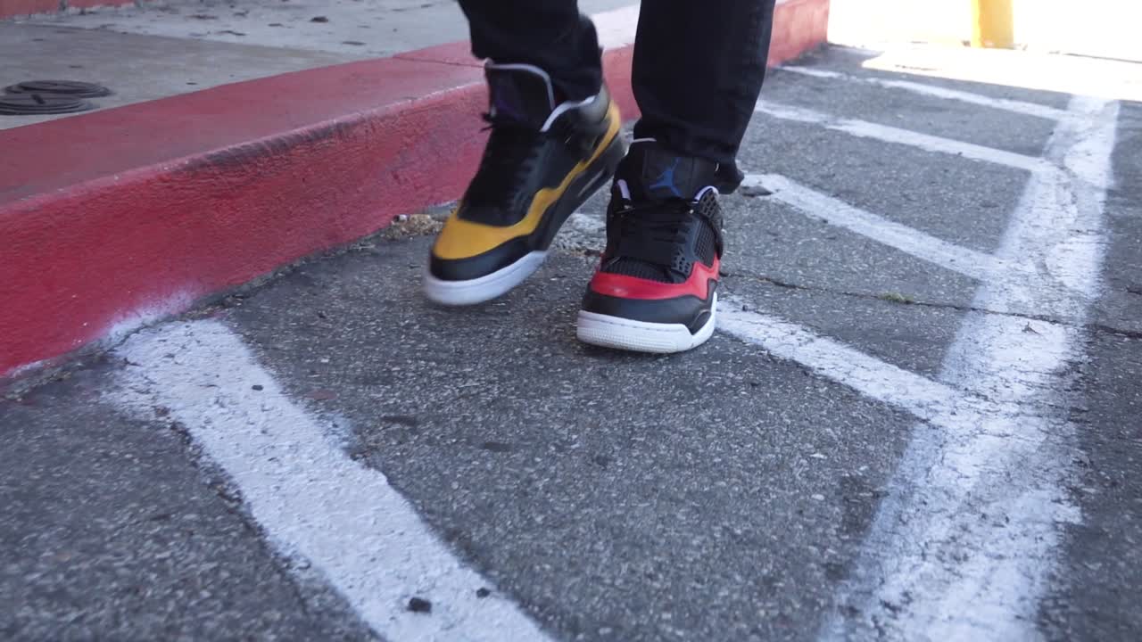 Premium stock video - Man walking in slow motion wearing red and yellow ...