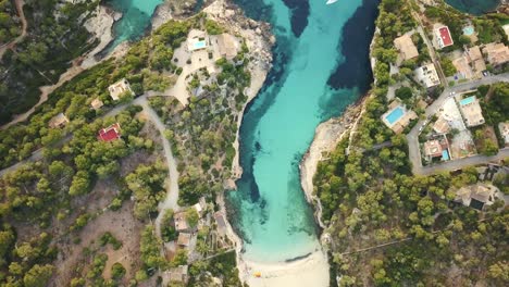 Birds-eye-view-of-the-beautiful-Cala-Llombards-with-clear-blue-turquoise-water-at-the-east-coast-of-Mallorca-in-4k---drone-video