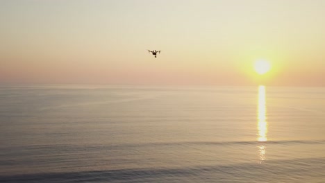 Drone-flying-while-sunset---sunrise-above-the-ocean---Professional-production---Quadcopter---DJI-Inspire-2-aerial-footage-in-4k