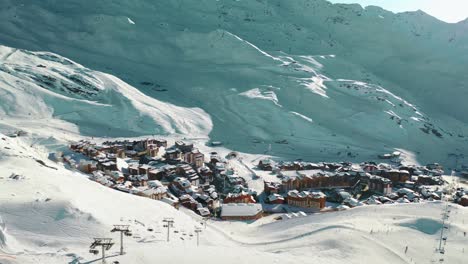 Ski-resort-village-at-bottom-of-mountain-ski-slope,-aerial-view