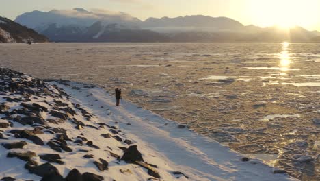 Abenteuerfotograf-Steht-Draußen-Bei-Kaltem-Wetter-In-Alaska,-Um-Den-Sonnenaufgang-Zu-Beobachten