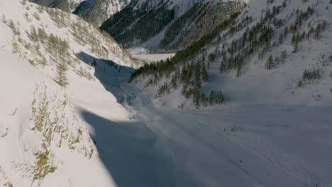 Amazing-ski-run-through-Austrian-Alps-mountain-valley,-winter-aerial-view