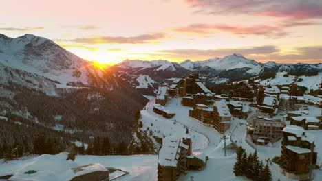 Dramatic-sunset-over-mountain-ski-resort-village,-Avoriaz-aerial-view