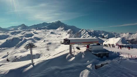 Aerial:-gondola-on-mountaintop-overlooking-ski-resort-winter-valley