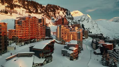 Avoriaz-French-ski-resort-accommodation-at-sunset-in-Alps,-winter-aerial-view