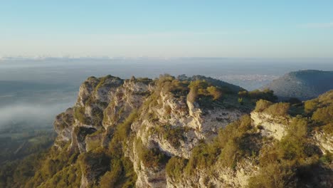 Drone-flight-next-to-cliffs-in-Mallorca---Beautiful-landscape-at-sunrise---Spanish-city-Llucmajor-in-the-background---Balearic-Islands-Spain