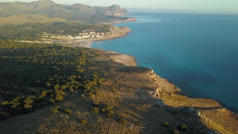 Breathtaking-4k-drone-footage-of-the-coastline-of-Mallorca---Cala-Mesquida-in-the-north-of-Majorca---Spanish-coastline,-Balearic-Islands---Mediterranean-Sea-while-sunrise---Calm-mornings