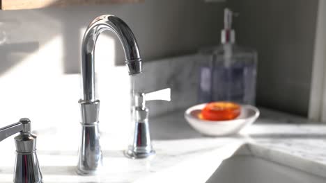 Close-Up-Of-Faucet-Dripping-In-Sunny-Bathroom-In-4K