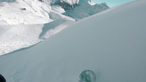 Snowboarder-in-Fresh-Powder-Snow-on-Ski-Slope-Mountain-in-Alps,-POV