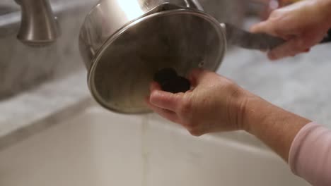 Woman-Straining-Pasta-Water-In-Sink-In-Slow-Motion