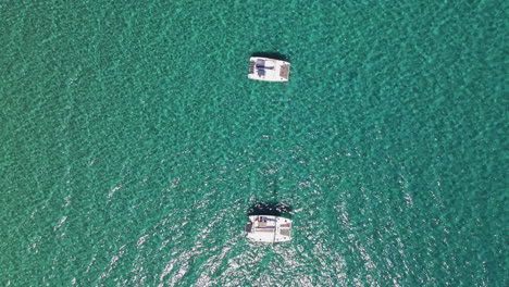 Overhead-Boats-in-Tropical-Clear-Blue-Water,-Aerial-Drone-Flying-Over-View