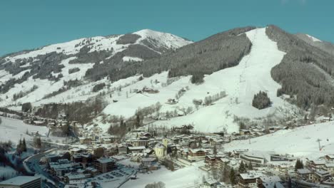 Saalbach-Ski-Resort-Snow-Covered-Mountain-Slopes-in-Austria,-Aerial
