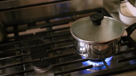 Panning-Shot-Of-Water-Boiling-On-Stovetop-In-Slow-Motion
