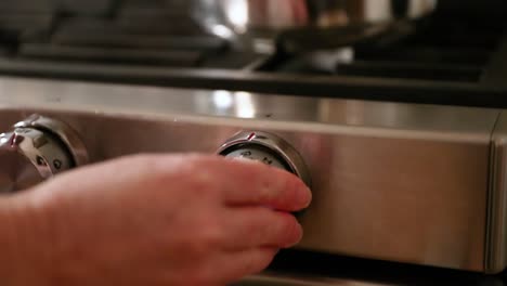 Close-Up-Of-Woman-Turning-On-Stovetop-In-Slow-Motion