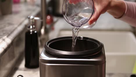 Woman-Pouring-Water-Into-Rice-Cooker-In-4K