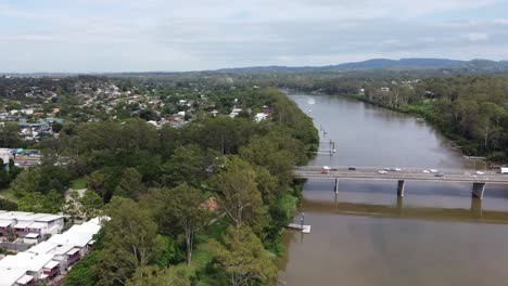 Aerial-view-of-a-brown-river-and-a-bridge