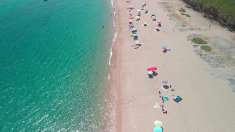 People-enjoying-a-sunny-day-on-Sardinia-Beach-in-Italy---Aerial