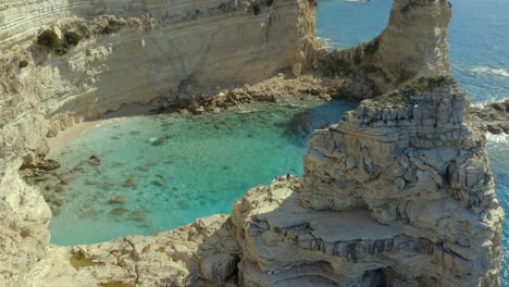 Boat-in-Secluded-Rocky-Cliff-Lagoon-in-Paxos-Island-Coast-in-Greece,-Aerial