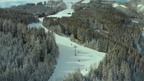 Ski-Trails-on-Snowy-Mountain-Slopes-at-Ski-Resort-in-Austria,-Aerial